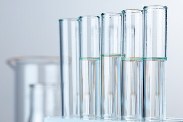Laboratory glass test tubes with transparent liquid close up