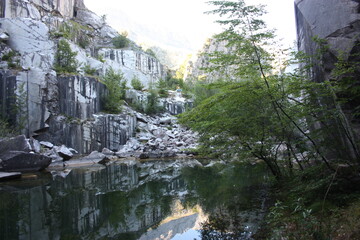 small natural lake inside a marble quarry