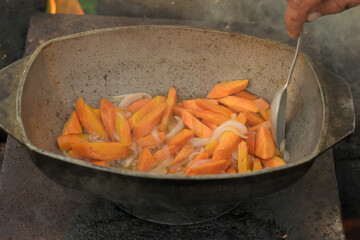 Pilaf in a cauldron with spoon