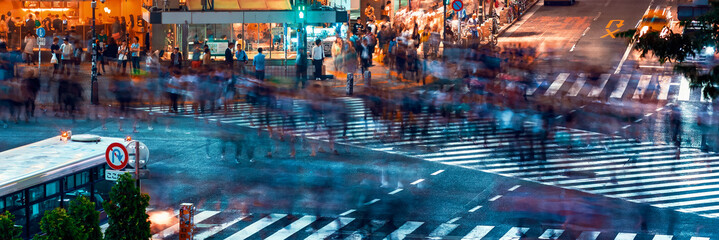 People and traffic cross the famous scramble intersection in Shibuya, Tokyo, Japan, one of the busiest crosswalks in the world