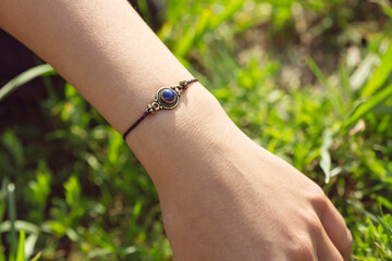 Mineral stone lapis lazuli pendant bead bracelet on female wrist