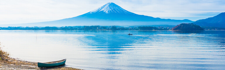 web banner alone boat mooring on ground at side of lake kawaguchi on morning time with fuji mountain background - obrazy, fototapety, plakaty