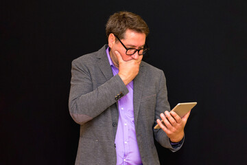 Middle age Business man uses and works with the pc tablet