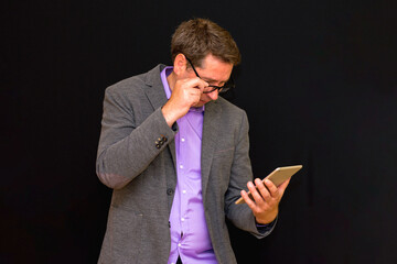 Side view of Middle age Business man uses and works with the pc tablet