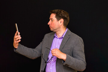 Side view of Middle age Business man uses and works with the pc tablet