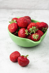 Fresh strawberries in a bowl on marble white table. Fresh nice strawberries. Strawberry field on fruit farm. Heap of Red strewberry on plate close up. Juice strawberry. Strawberry field on fruit farm.