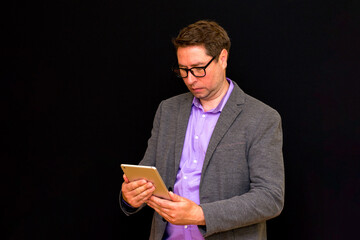 Middle age Business man uses and works with the pc tablet