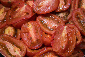 Roasted tomatoes with herbs, on a baking tray
