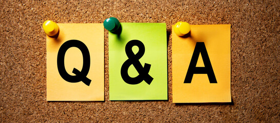 Business concept. The inscription on the multicolored stickers questions and answers, shrivelled.