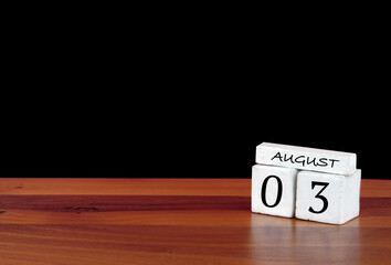 3 August calendar month. 3 days of the month. Reflected calendar on wooden floor with black background