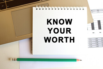 Notepad with the text is on the laptop keyboard. Minimal work space. Business concept.