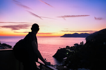 Man looking at the sunset in Cinque Terre, Italy