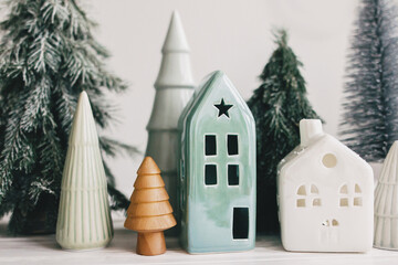 Happy holidays. Miniature cozy village, ceramic houses, wooden and handmade christmas trees....
