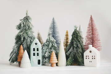 Christmas little houses and trees on white background. Festive modern decor. Happy holidays....
