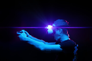Man with virtual reality headset is playing game. Image with glitch effect.