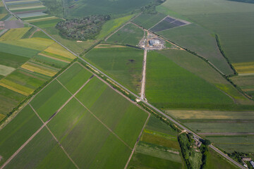 Rows of soil before planting. Furrows row pattern in a plowed field prepared for planting crops in spring. Aerial top view of a different agriculture fields in countryside on a spring day. Drone shot