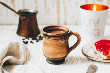 Coffee, toast and jam on a white wooden table