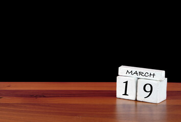 19 March calendar month. 19 days of the month. Reflected calendar on wooden floor with black background