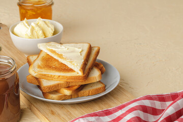 Slice of fresh bread with butter and jam on table