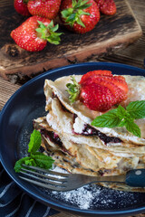 Polish pancakes with jam, cheese and strawberries.
