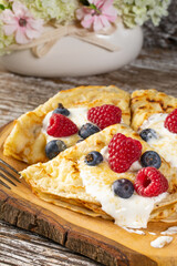 Pancakes with white cheese and fruit.