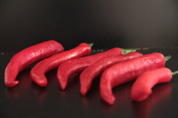 colorful peppers on a black background
