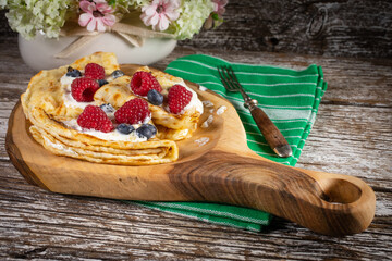 Pancakes with white cheese and fruit.