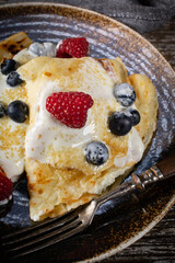 Pancakes with white cheese and fruit.