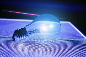 Shining light bulb and above it pink neon line luminous.Black luminous mesh is reflected in the...
