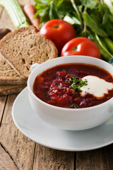 Traditional Ukrainian Russian borsch. Beetroot soup on wooden table.	