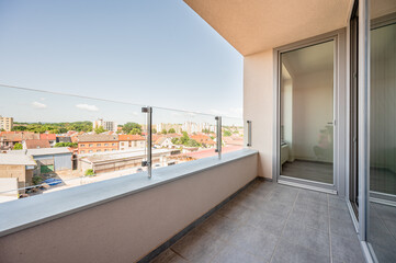 View from balcony, sunny day, clouds, wide angle real estate photo.