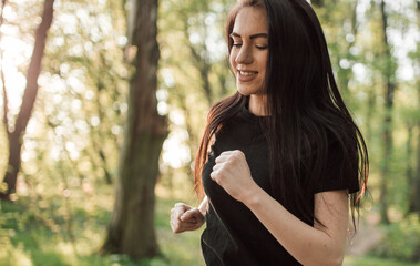 Young sporty woman running in forest