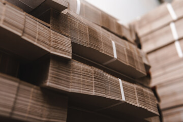Products and corrugated cardboard. Factory for the manufacture and processing of paper. Copy space, stacks. Selective focus. Capacities and packaging. stock