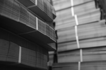 Products and corrugated cardboard. Factory for the manufacture and processing of paper. Copy space, stacks. Selective focus. Capacities and packaging. stock. Black and white
