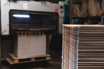 Products and corrugated cardboard. Factory for the manufacture and processing of paper. Sheets, stacks. Selective focus. Capacities and packaging. Large format printing. Industrial Printer