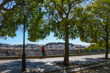 View of old town and Sao Jorge Castle from Sao Pedro de Alcantara viewpoint (miradouro), in Lisbon,...