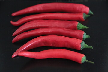 colorful peppers on a black background
