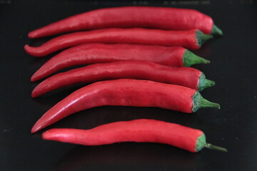 colorful peppers on a black background
