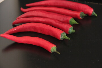 colorful peppers on a black background
