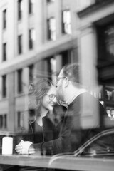 A young heterosexual couple enjoying a conversation at a nyc coffee shop