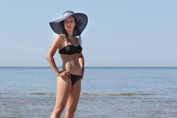 young girl in bikini against the sea