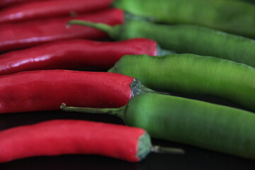 colorful peppers on a black background
