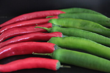 colorful peppers on a black background
