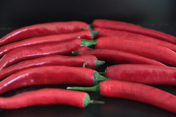 colorful peppers on a black background
