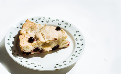 slice of homemade berry pie in a white plate with green pattern. Homemade sweets, homemade pie, cake and pastries 