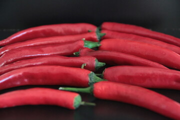 colorful peppers on a black background
