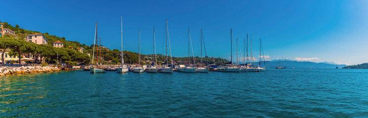Fototapeta premium Sailing boats moored along a wharf in Porto Venere, Italy in the summertime