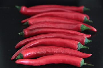colorful peppers on a black background
