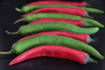 colorful peppers on a black background
