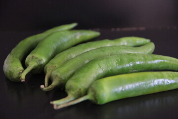 colorful peppers on a black background
